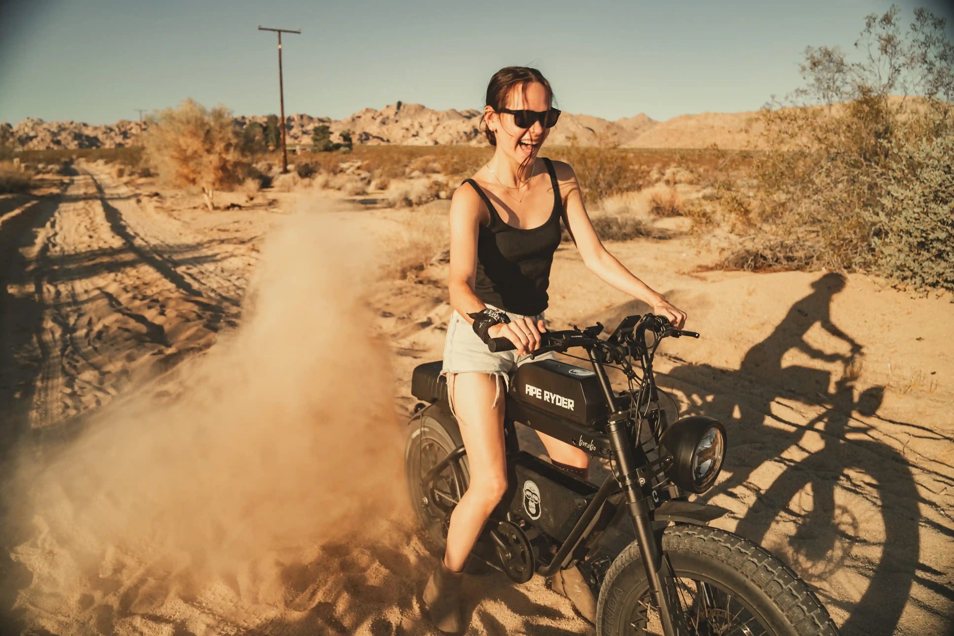 a girl with her ape ryder e-bike in desert