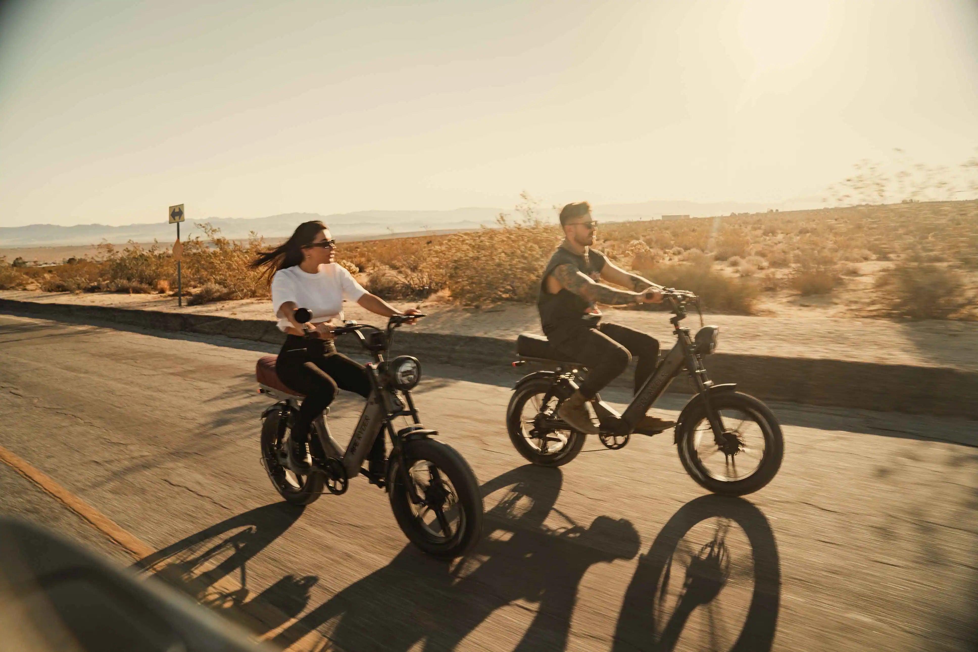 a man and a woman riding ape ryder electric bikes