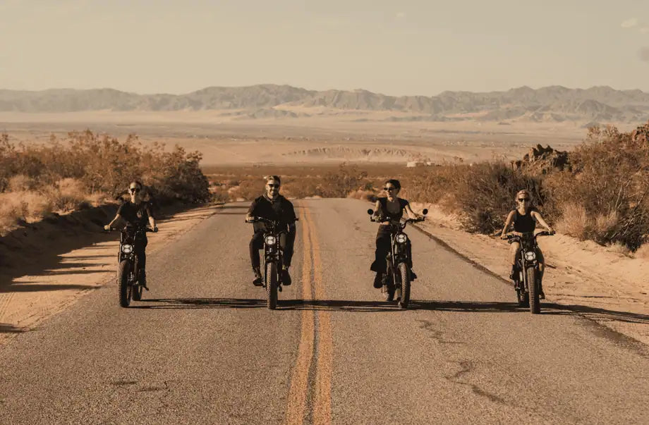 four people gang riding e-bike