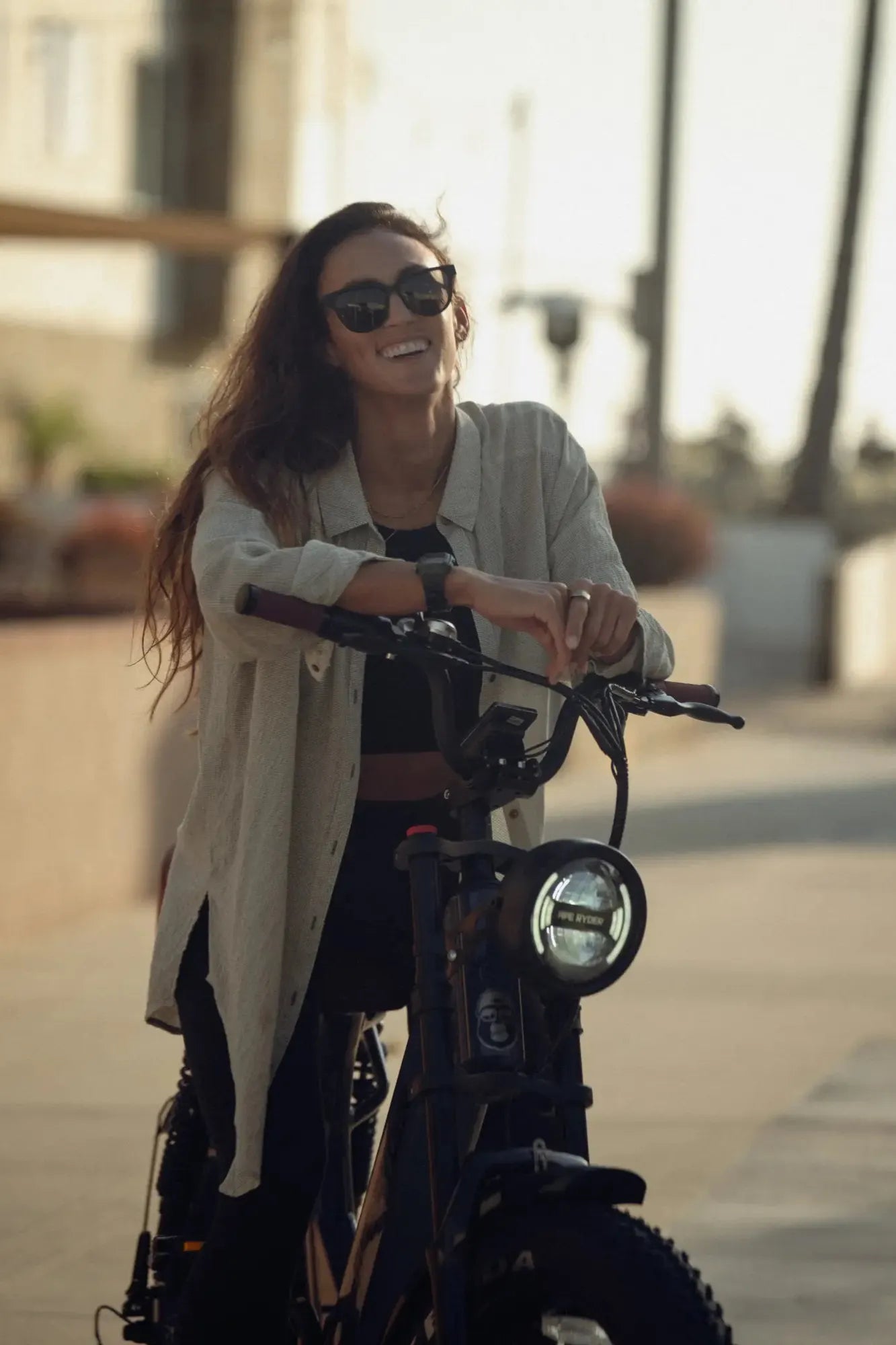 woman standing with her e-bike